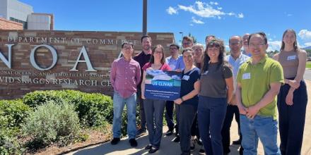 The PPAI Panel poses with a US CLIVAR sign in front of NOAA PSL in Boulder, CO