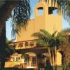 photograph of a house and palm trees